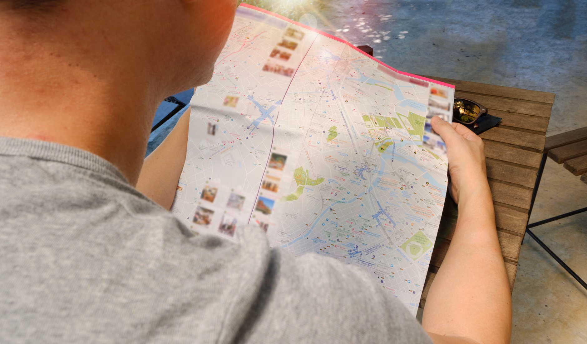 A person mapping out local attractions using a wall map and sticky notes.