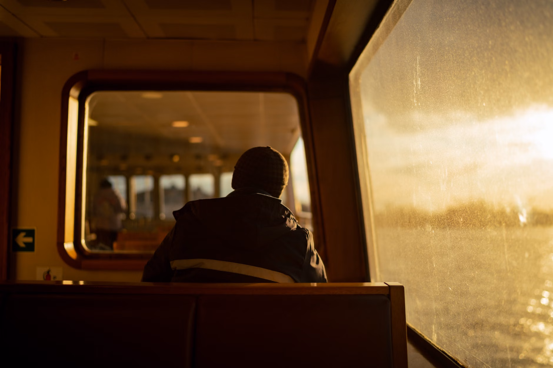 Cozy cabin interior looking out at a winter sea.