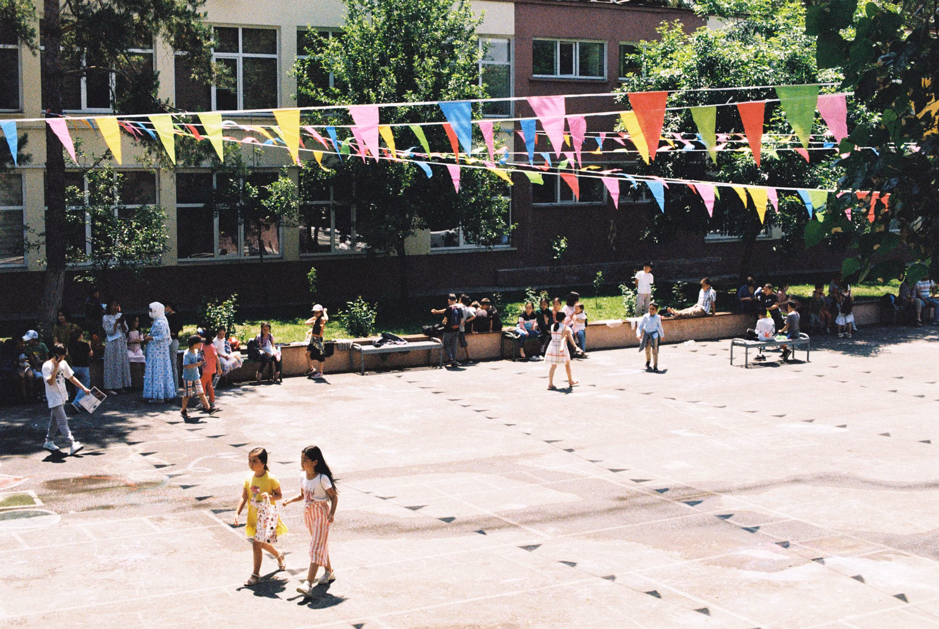 Parents and children socializing in a shared urban courtyard.