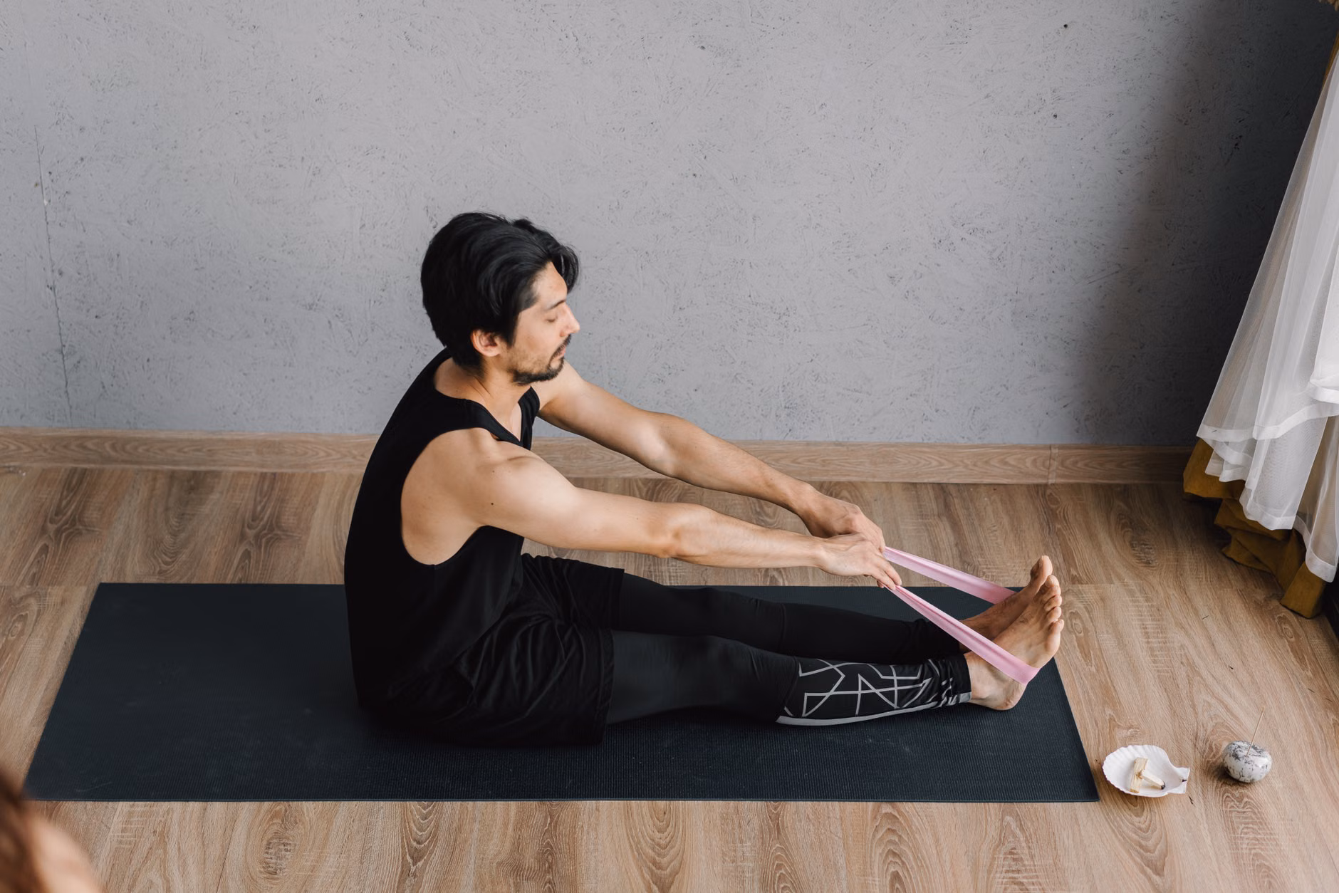 Person practicing gentle stretching exercises at home.