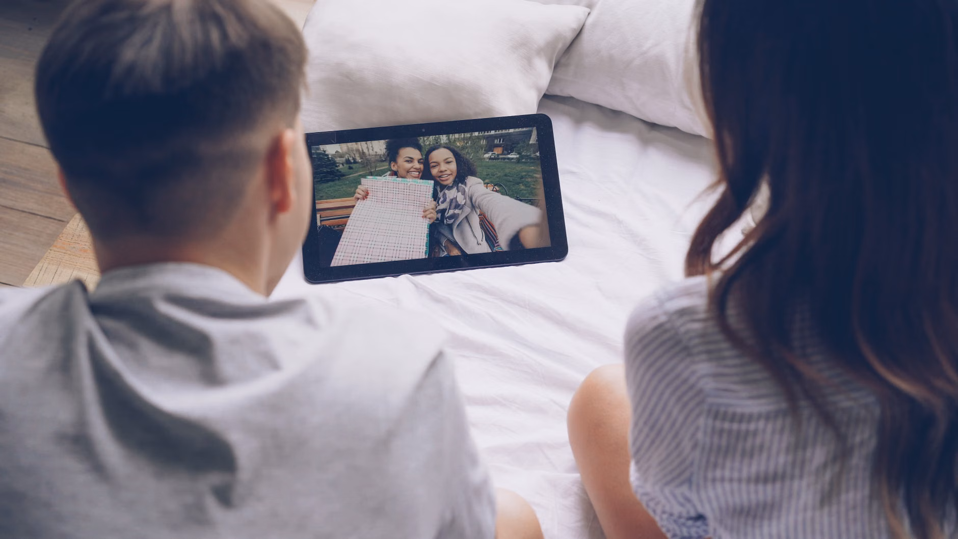 A family viewing digital memories on a tablet in a secure home environment.