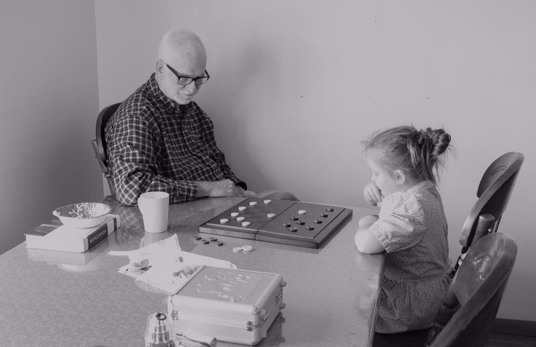 A family playing board games on a train table during a slow-transit trip.