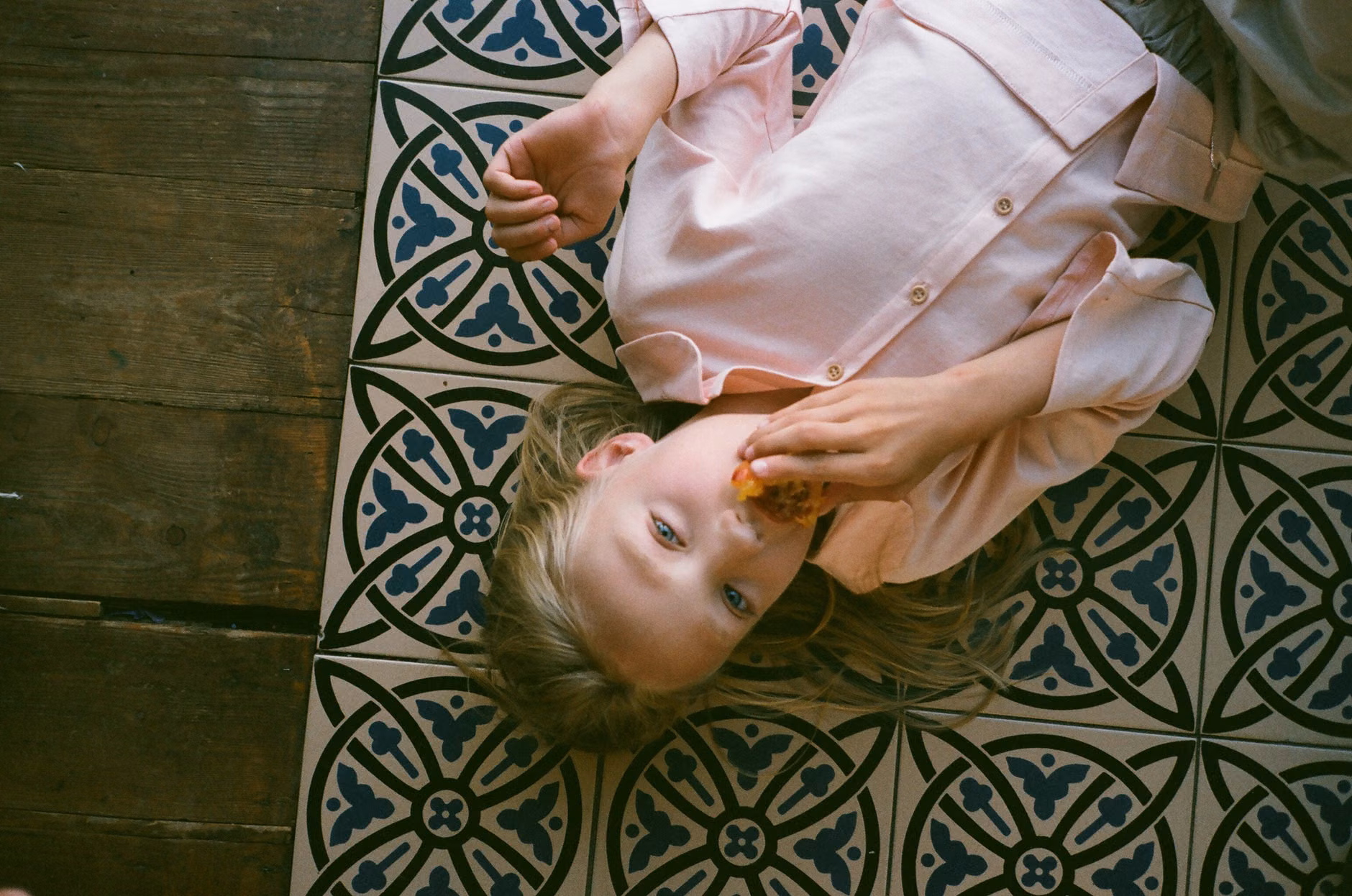 Child wearing a unique shirt crafted from upcycled fabric patterns.