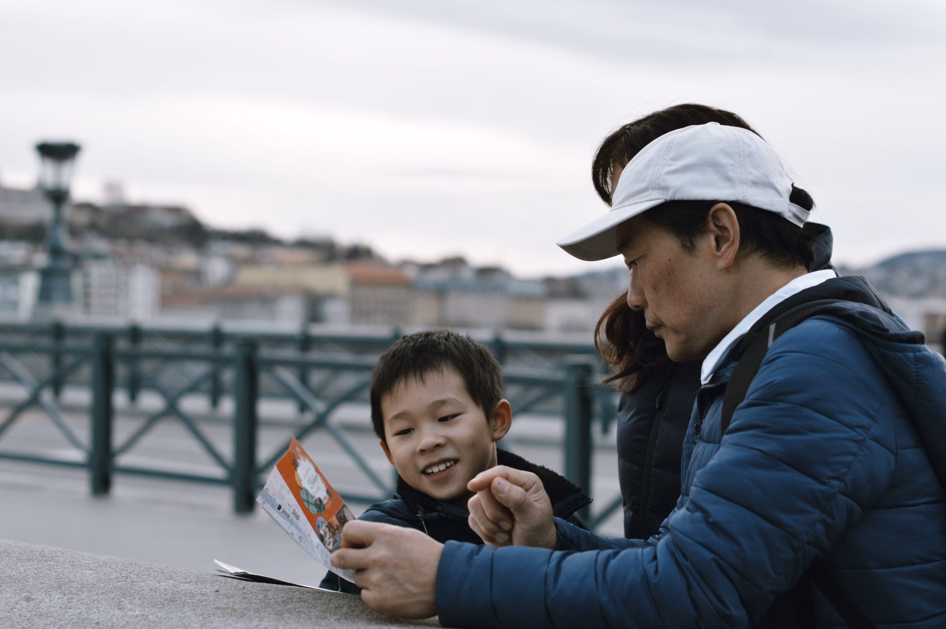 Parent and child exploring local park with a map.