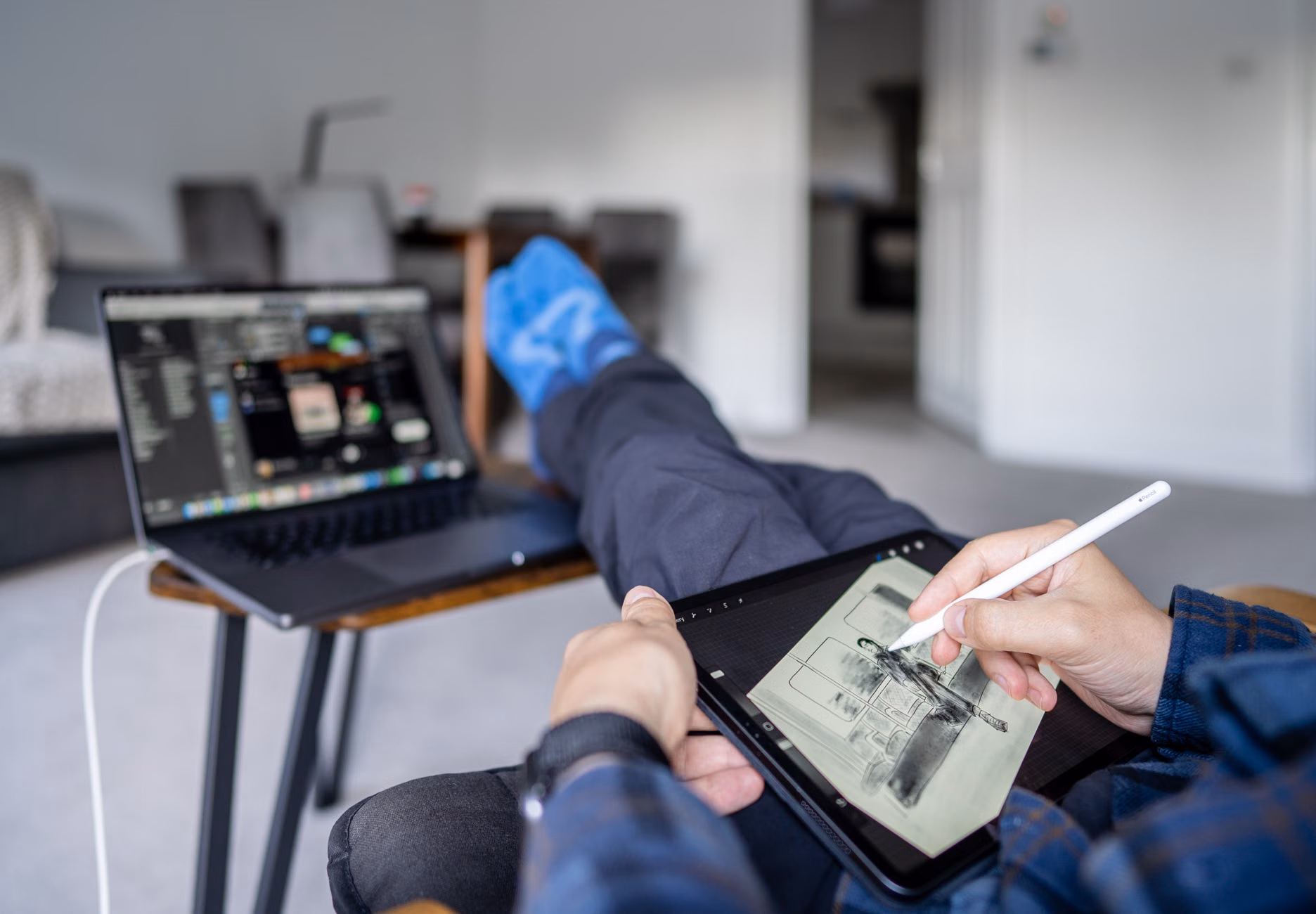 A freelancer working in a shared family space, illustrating the challenge of securing work devices among family gadgets.