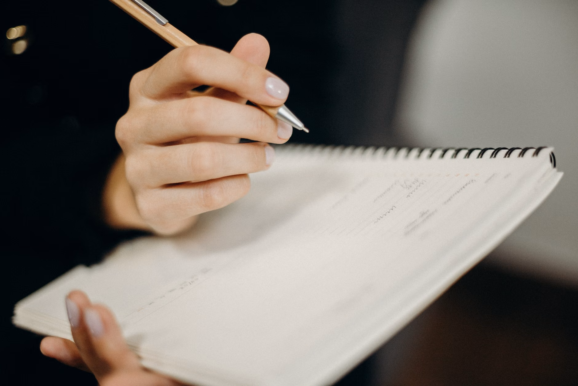 A paper planner and pen, symbolizing manual organization.
