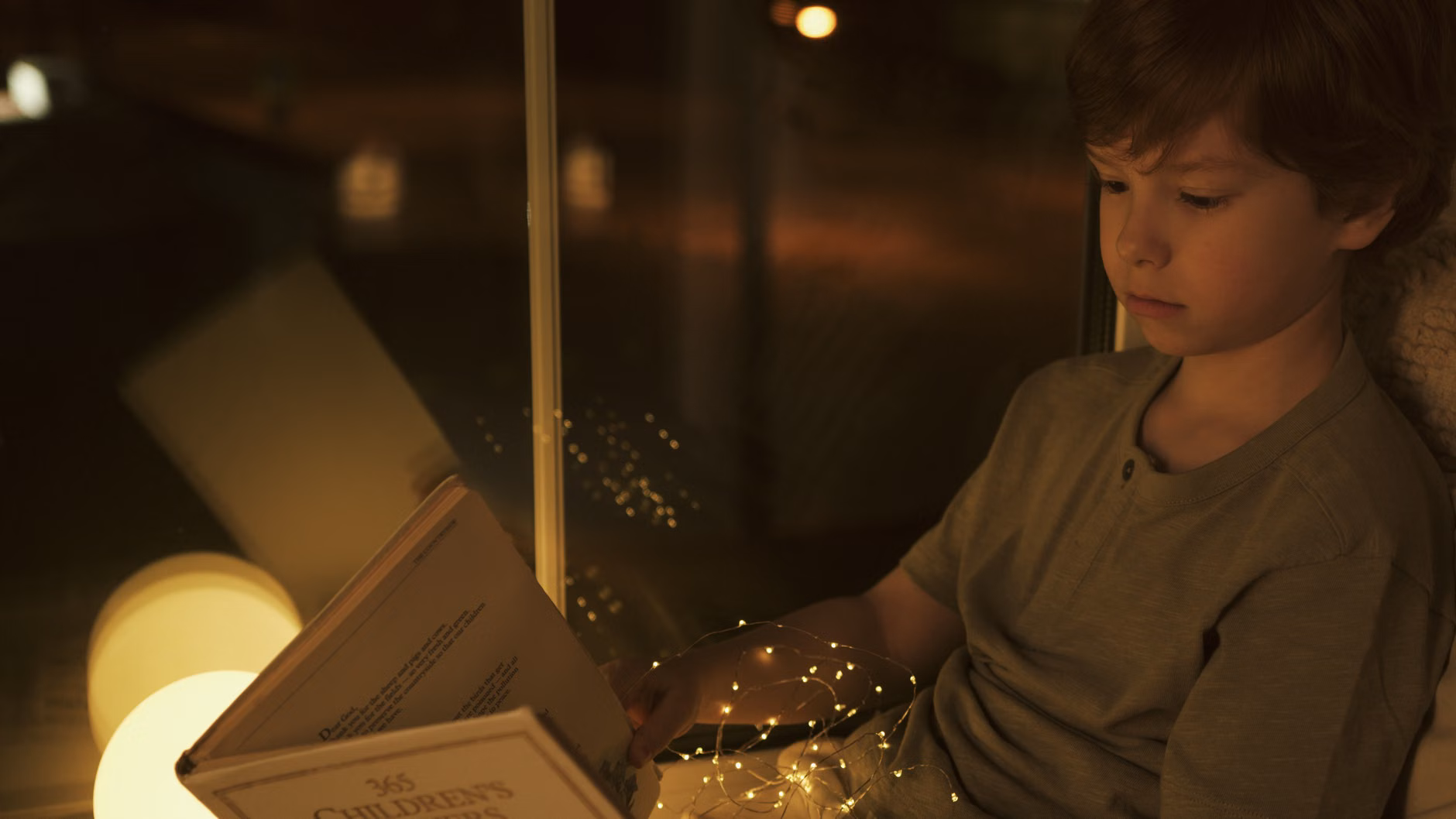 A comfortable, sensory-friendly reading nook with warm lighting.
