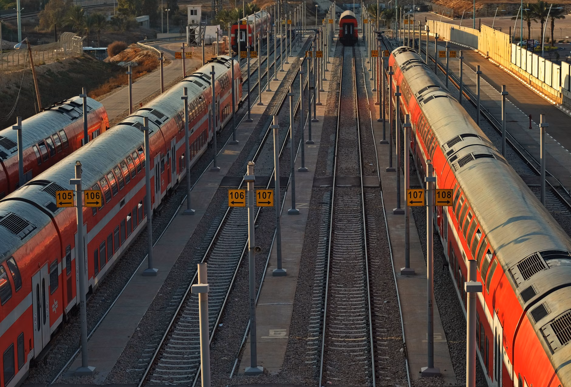 A peaceful train station at sunset by the coast.