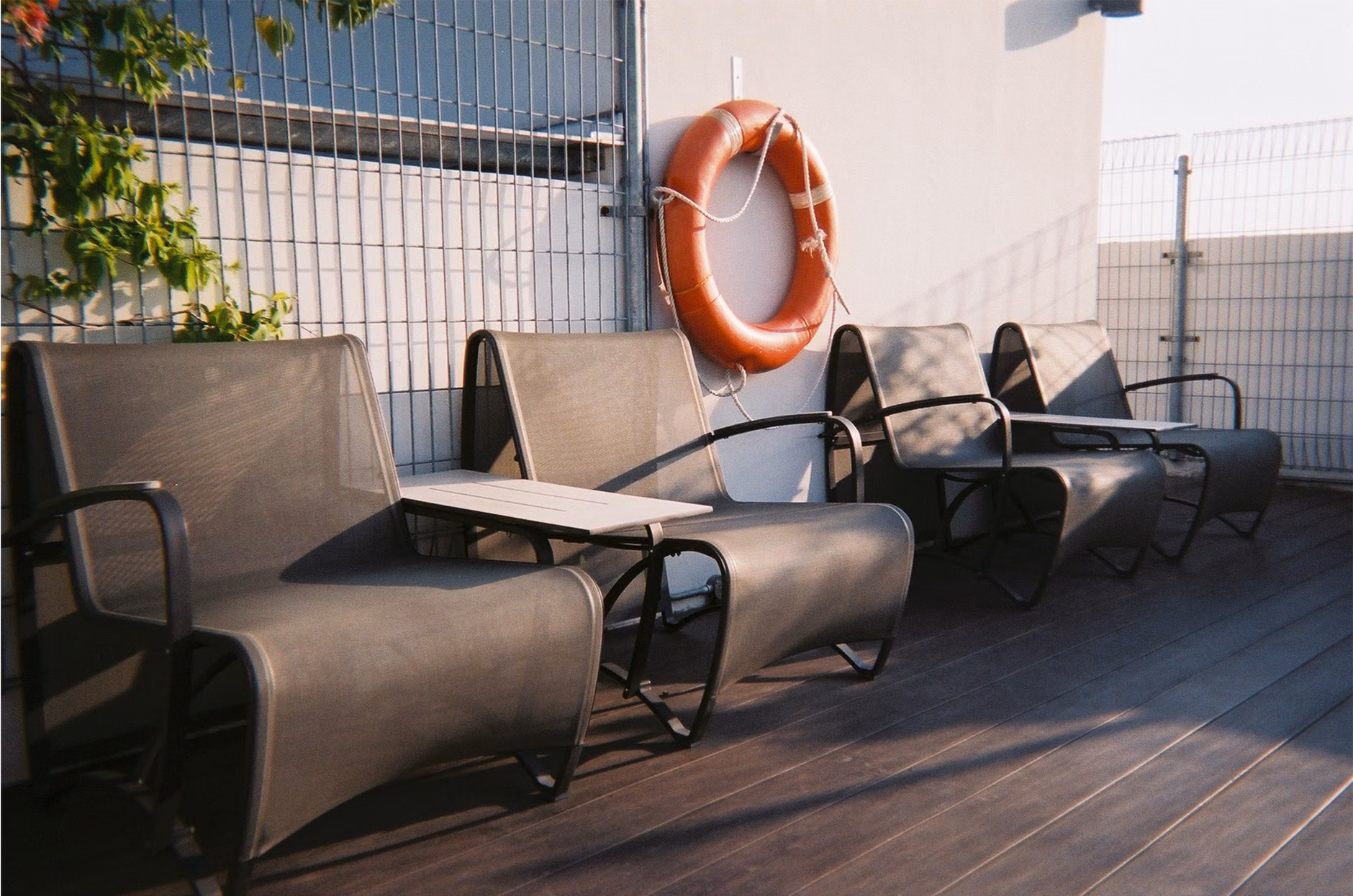 Safety-conscious balcony design with secure netting and comfortable seating.