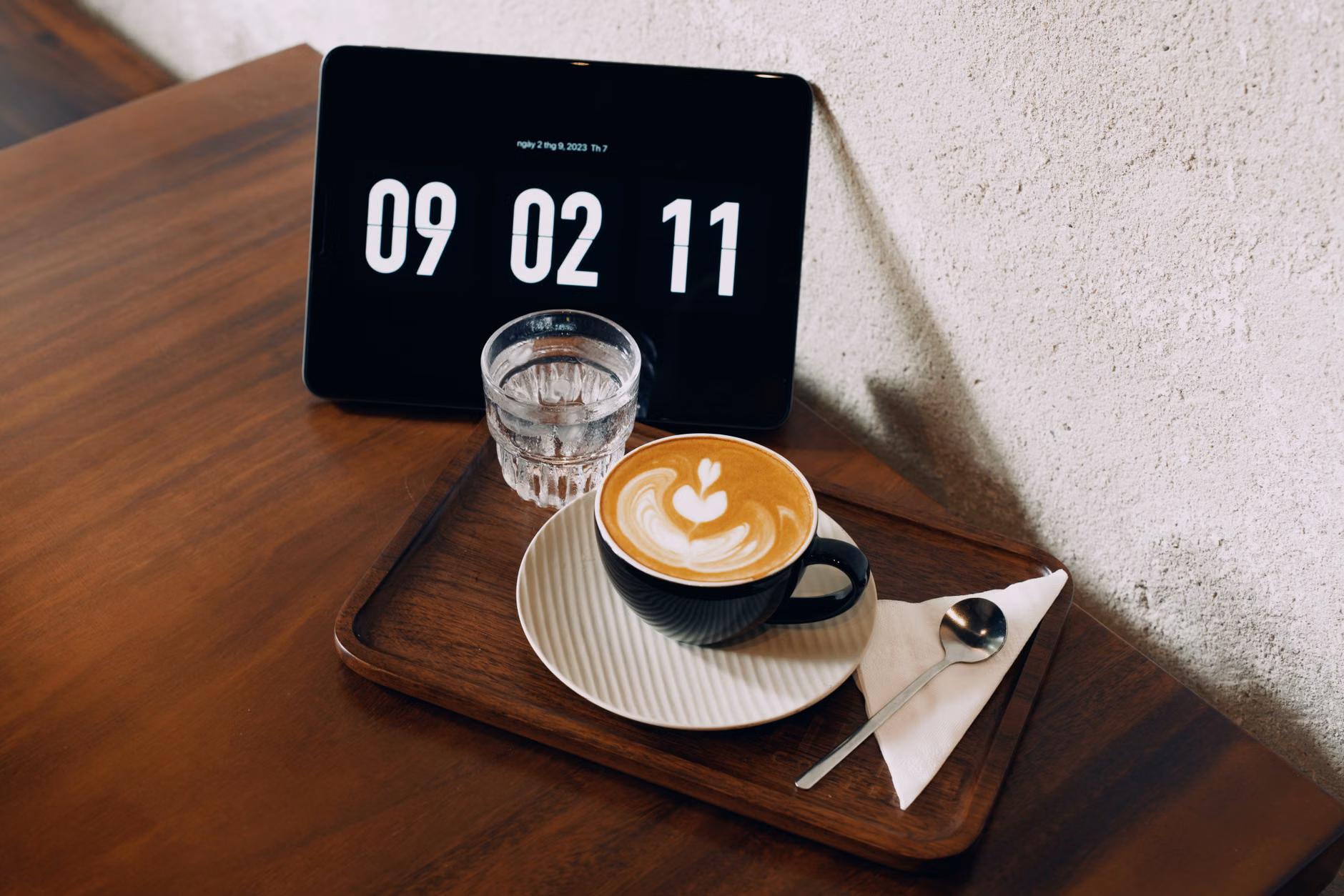Digital clock and water glass representing sleep routine.