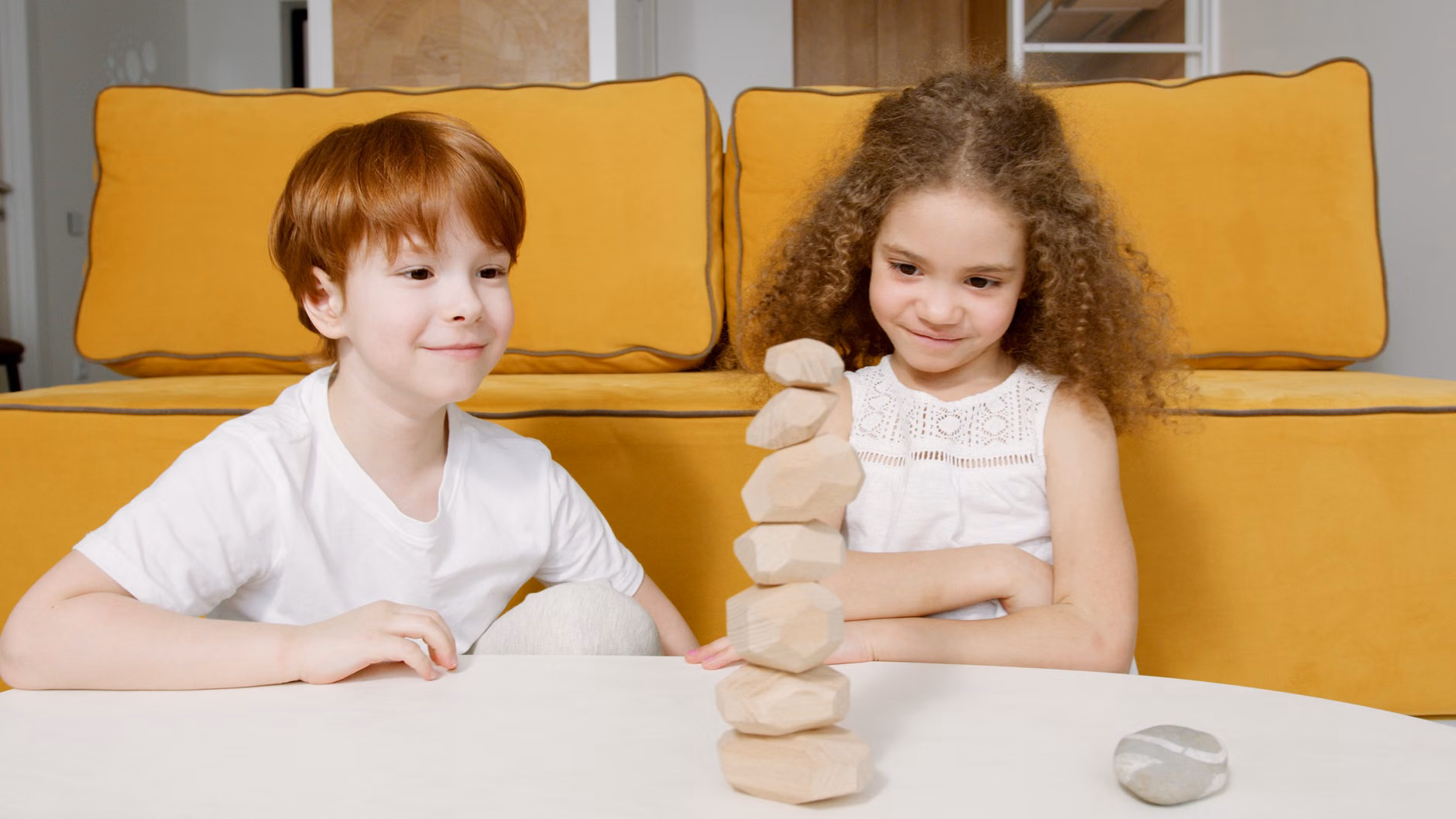 Two siblings negotiating rules for a cooperative game.