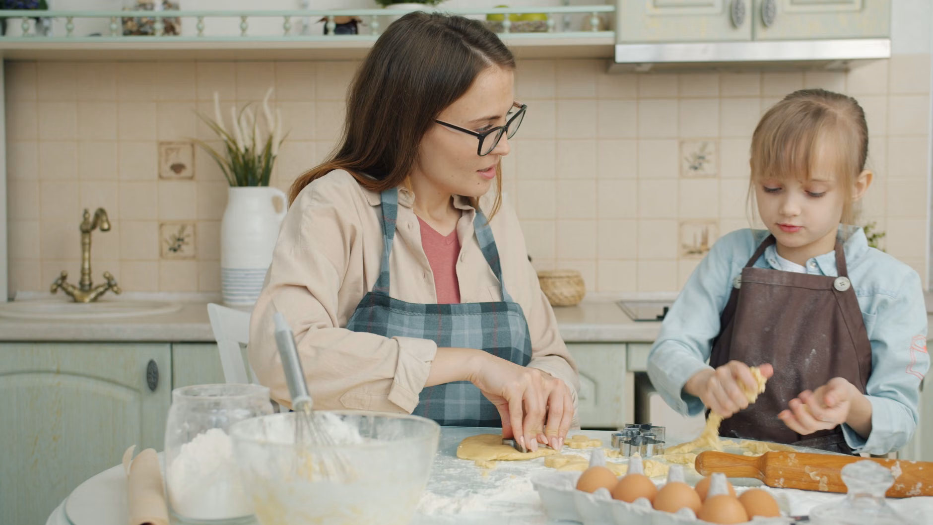 A parent and child cooking a traditional family recipe together at home.