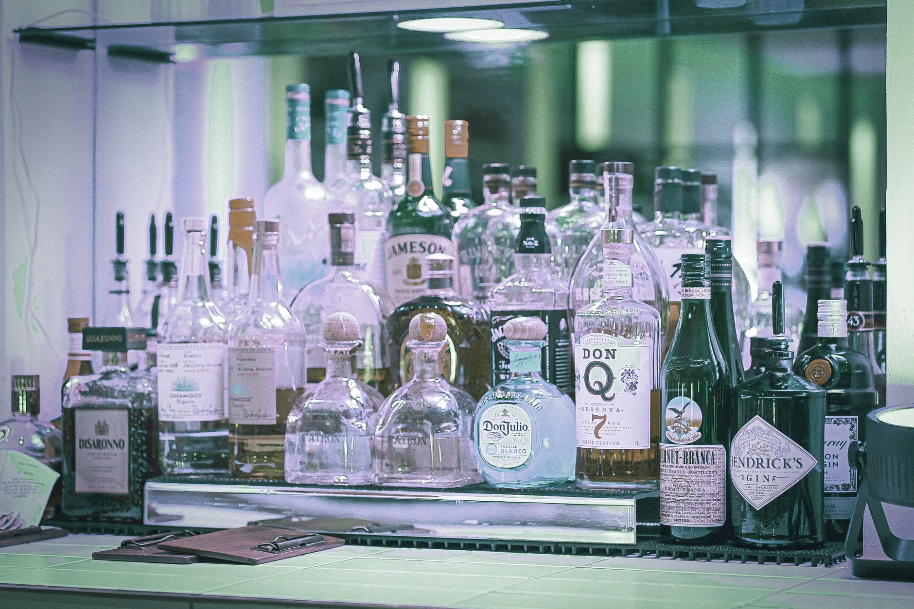An elegant assortment of zero-proof spirits and mixers arranged on a wooden serving tray.