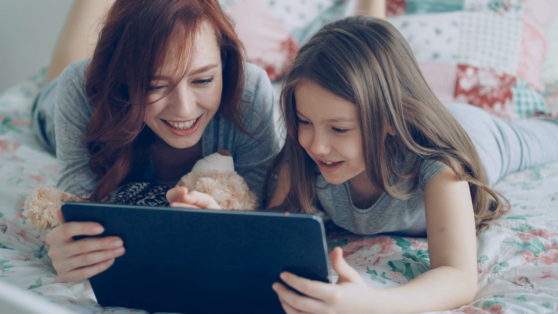 A parent and child celebrating a successfully repaired tablet.