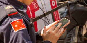 A parent checking security settings on a phone for a child's smartwatch.