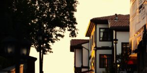A quiet, historic street at dawn representing off-peak travel.