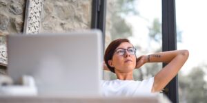 A professional taking a thoughtful break from work to focus on family life.