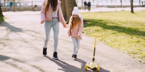 A parent and child enjoying a quiet weekend walk in a local park.