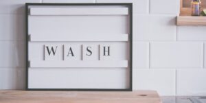A clean, modern visual schedule board mounted on a kitchen wall to help manage family routines.
