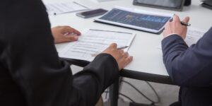A person reviewing salary data on a tablet in a bright home office.