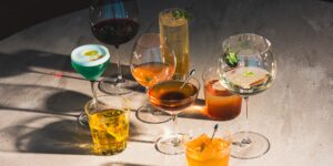 Elegant dining table set with sophisticated non-alcoholic cocktails for a social gathering.