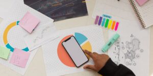 A clean desk setup for financial planning with a smartphone and coffee.
