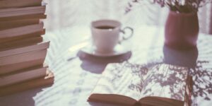 A peaceful morning scene with a book and coffee, symbolizing a tech-free start to the weekend.