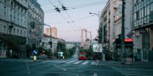 A peaceful, empty city street at dawn representing quiet tourism.
