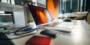 A clean desk setup featuring a secure external hard drive and tablet for digital document management.