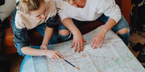 A family planning a trip using a map in a historic village.