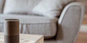 Modern smart home thermostat in a cozy living room setting.