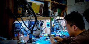 A community workshop filled with tools and electronic devices for repair.