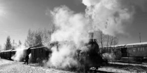 A vintage steam train arriving at a station, representing a nostalgic family travel experience.