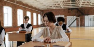 A focused pre-teen studying at a desk in a well-lit room.