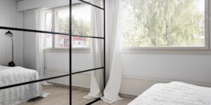 A clean, minimalist bedroom setting with sleep tracking tools to represent a sleep audit.
