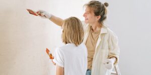 Two parents collaborating on a home DIY project in a garage.