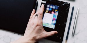 A smartphone on a desk showing a home inventory app interface.