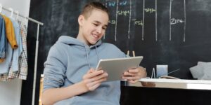 A pre-teen engaged in digital learning at a modern home desk.