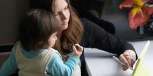 Parent and child exploring family history together using a tablet.