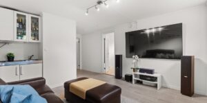 Modern home battery system installed in a bright, contemporary living room.