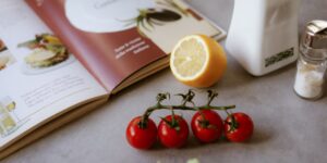 A organized kitchen table with seasonal produce and planning tools for bulk buying.