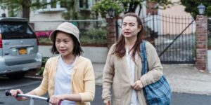 A parent and child exploring a historic neighborhood street together.