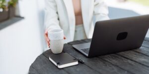 Professional closing laptop at sunset representing work-life boundaries