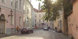 A quiet, historic street at sunrise representing the calm of off-peak travel.