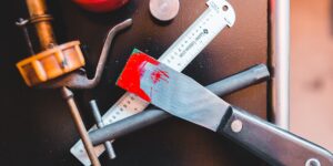 A DIY kitchen appliance repair setup featuring tools and a disassembled device.