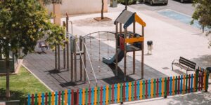 A modern, child-friendly urban balcony with plants and play areas.