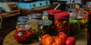 An organized pantry filled with glass jars and seasonal produce.