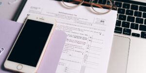 A laptop and passport on a desk representing international tax planning for 2026.