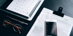 Modern desk setup with a smartphone and calendar app for family organization.