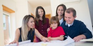 Parents planning a cooperative childcare schedule together in a living room.